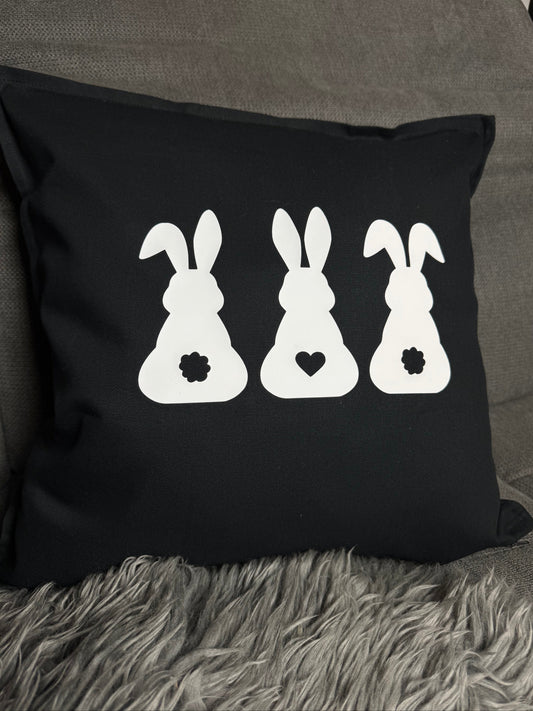 Cushion printed with rabbits in black